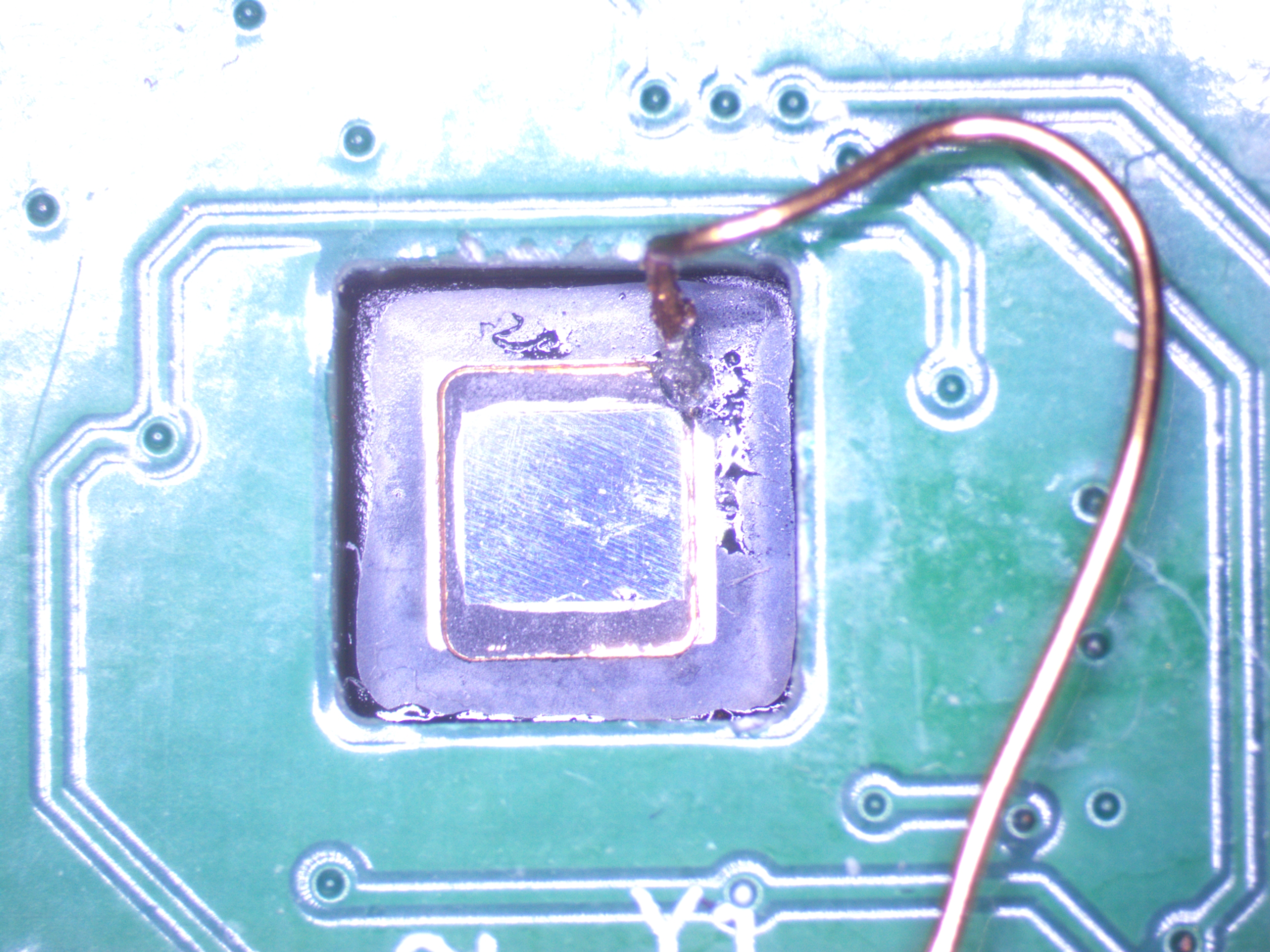 Backside-decapsulated RP2350 mounted on the analysis daughterboard